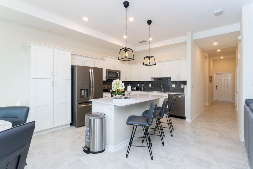 The fully equipped kitchen features modern appliances, sleek cabinetry, and all essential cookware and utensils, making it perfect for preparing meals with ease.