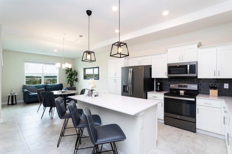 The fully equipped kitchen features modern appliances, sleek cabinetry, and all essential cookware and utensils, making it perfect for preparing meals with ease.