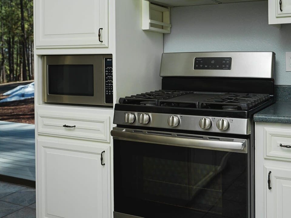 The kitchen is equipped with a large gas range and microwave. Whether you're simmering a savory sauce or quickly heating up leftovers, the combination of these top-notch appliances ensures that your cooking experience is efficient and enjoyable.