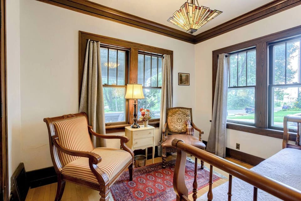 Sitting area in bedroom 5 with 2 oversized antique chairs.