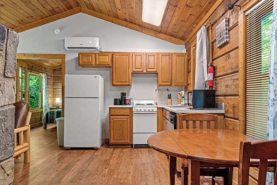 This fully stocked kitchen makes meal prep easy with modern appliances and a cozy dining nook—just right for home-cooked meals..
