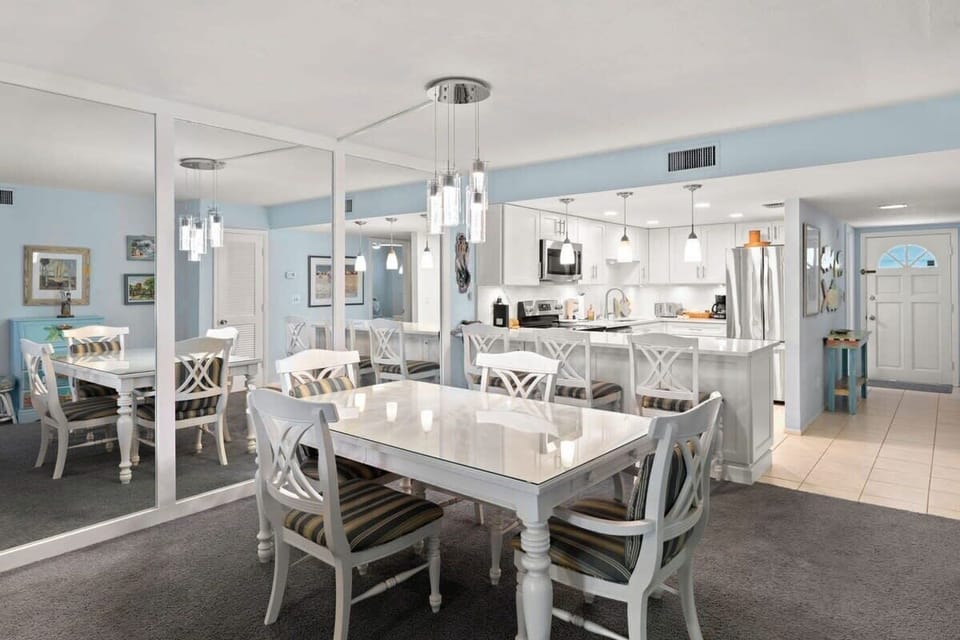 Dining table with seating for four and kitchen peninsula with seating for an additional three