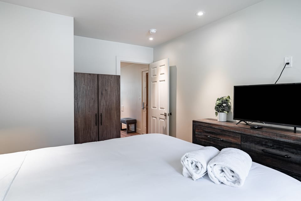 Queen-size bed and a TV in the bedroom.