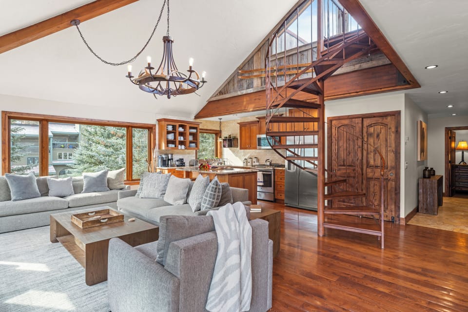 Spacious living room with spiral staircase.