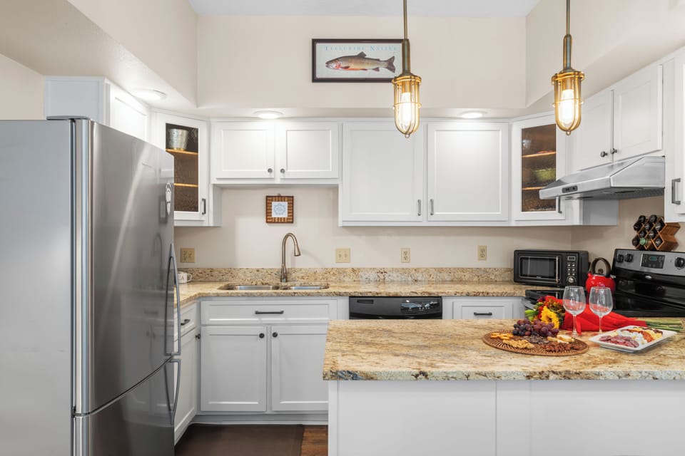 Bright, fully equipped kitchen with granite counters—perfect for relaxed mountain-side cooking.