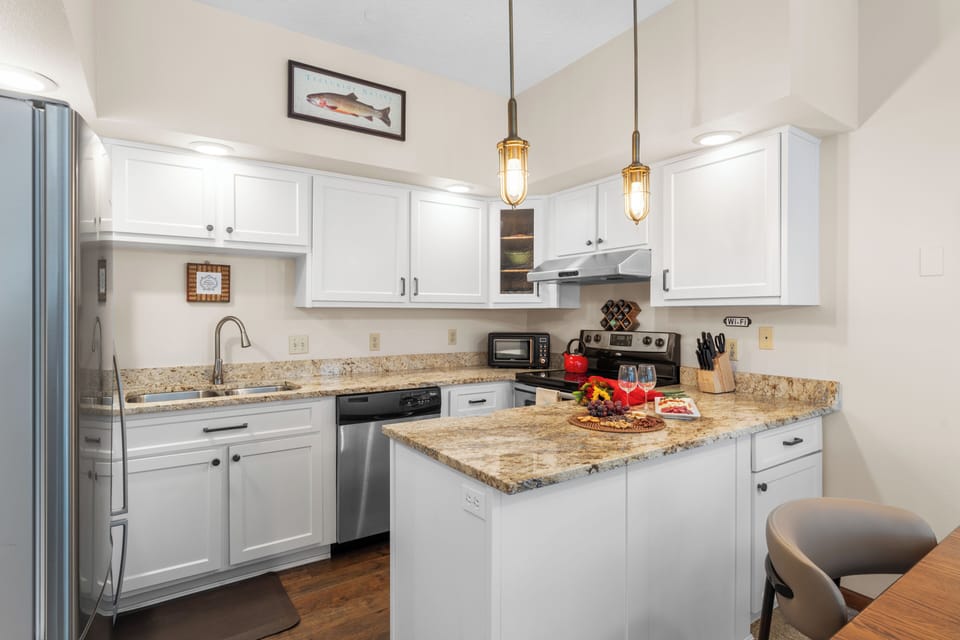 Bright, fully equipped kitchen with granite counters—perfect for relaxed mountain-side cooking.