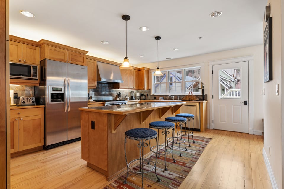 Welcoming kitchen features an island with counter-top seating and modern appliances.
