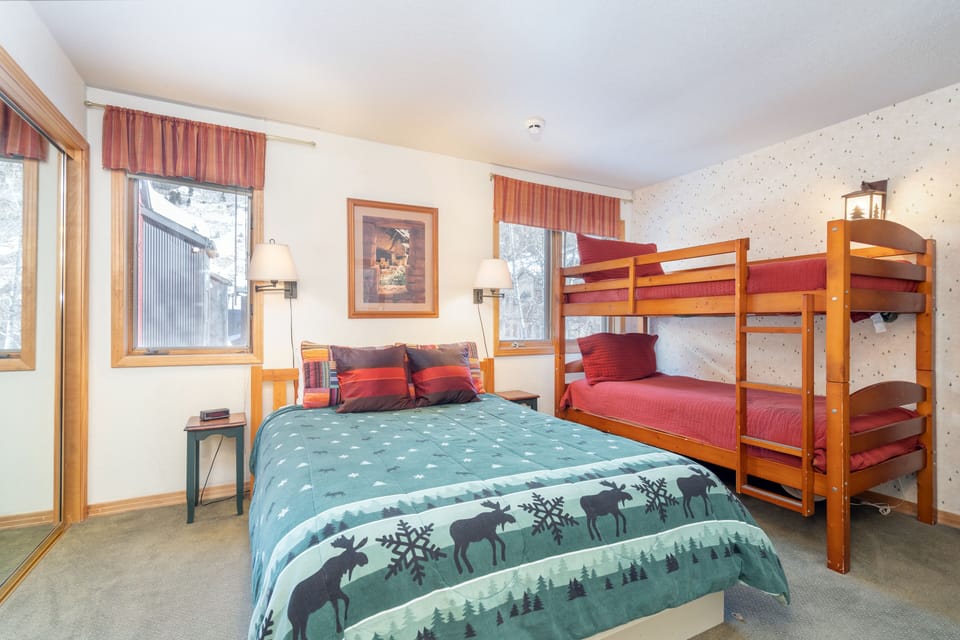 Bedroom 2 features a queen bed and a bunk bed.
