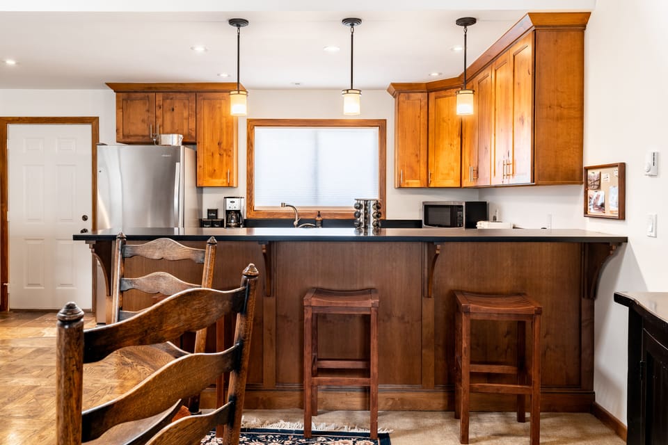 Additional barstool seating at the kitchen counter.