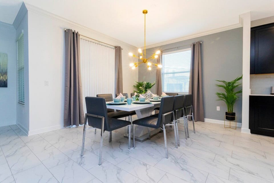This space is an elegant and spacious dining room, perfect for a guest seeking a comfortable and luxurious experience. 