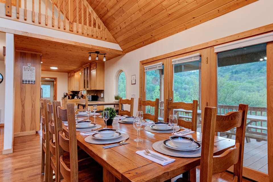 Main floor living room with dining table that sits eight + two at kitchen island