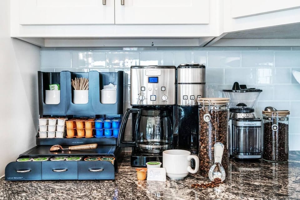 Complete Coffee Bar Experience: Discover a Fully Stocked Selection, from Coffee Pot to Single-Use Pod combo machine! Indulge in Caffeinated, Decaffeinated, sweeteners, and an array of creamer options. Utilize the grinder for your fresh ground cravings!