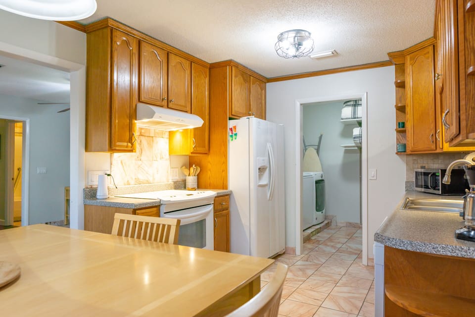 The kitchen leads into the laundry room