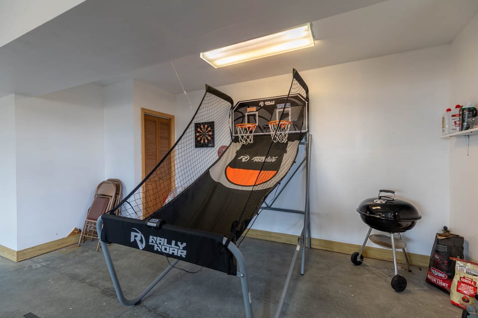 Friendly competition awaits in the garage game room, stocked with an arcade hoops game and dartboard for rainy mountain days.
