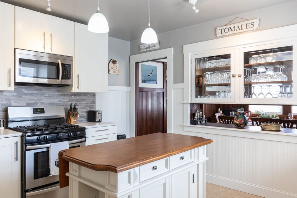 Large kitchen space with an island that can fold out for more counter space.