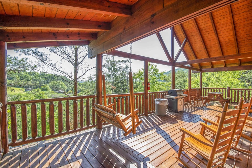 Spacious deck with rocking chairs and peaceful mountain scenery