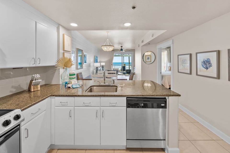 Your modern kitchen features granite countertops and stainless appliances, with ocean views creating a serene cooking atmosphere.