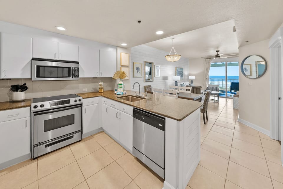 Cook your favorite meals in this bright, fully-equipped kitchen with granite counters and stunning ocean views.