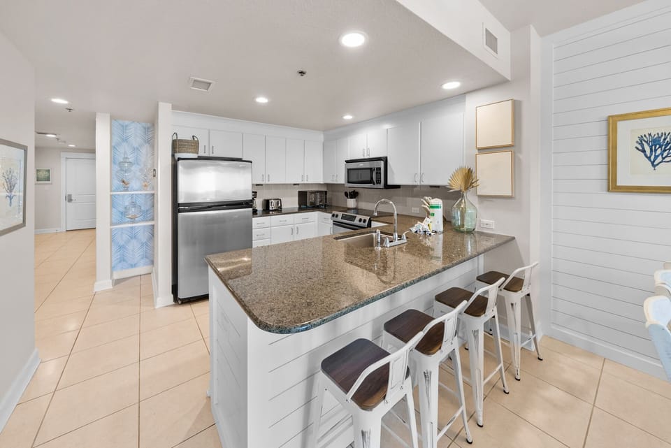 Your modern kitchen features granite countertops, stainless steel appliances, and a breakfast bar where you can enjoy morning coffee together.
