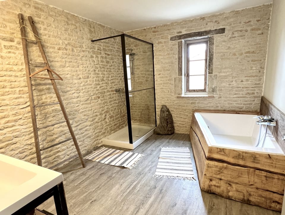 Chalet, Bathtub, Courtyard View | Bathroom | Rainfall showerhead, towels, soap, toilet paper