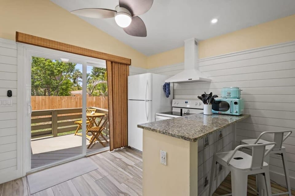 The bright kitchen and living area opens up to an outdoor patio perfect for soaking up the sun