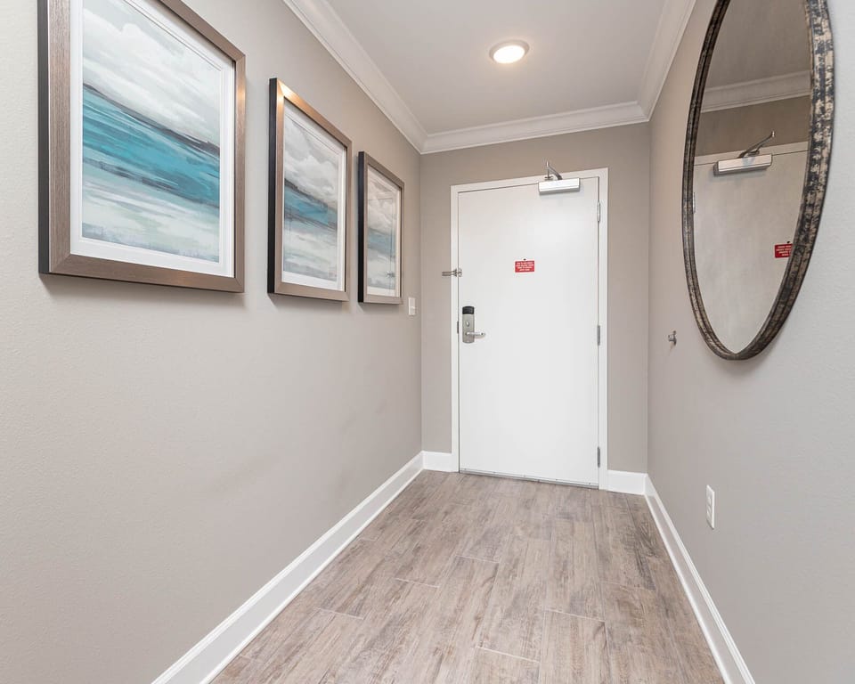 Step into a welcoming hallway adorned with calming art, setting the tone for your coastal getaway experience
