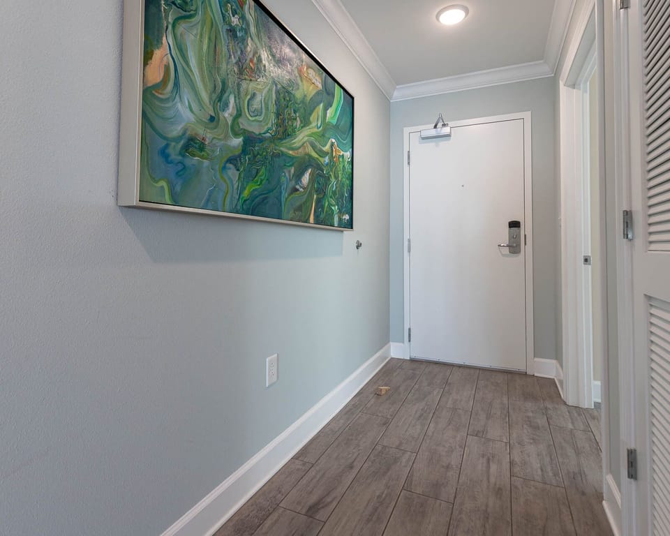Step into a bright entryway, where vibrant artwork welcomes you to your relaxing coastal getaway