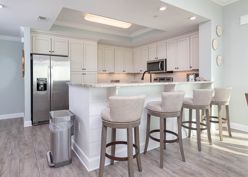 Sip your morning coffee at the breakfast bar and get ready for a beach day in this stylish space