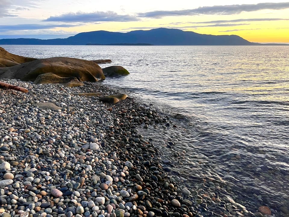 Sink into the sand at Sunset Beach - just a short drive from Driftwood Dreams. Lean against a piece of driftwood, watch the sun drop behind the islands, and stay until the light is gone. 