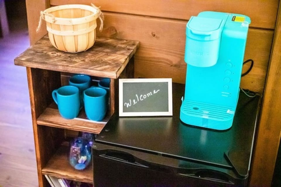 Keurig coffee maker, coffee pods, coffee mugs, wine glasses, mini fridge, games