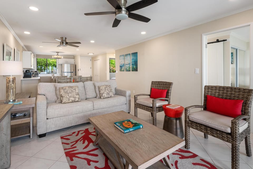 Living room with sliding doors to lanai and peekaboo ocean views