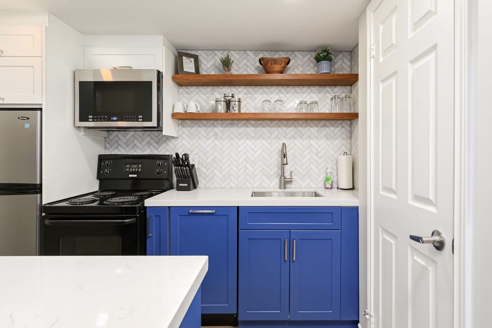 Microwave and stove located in the kitchen. 