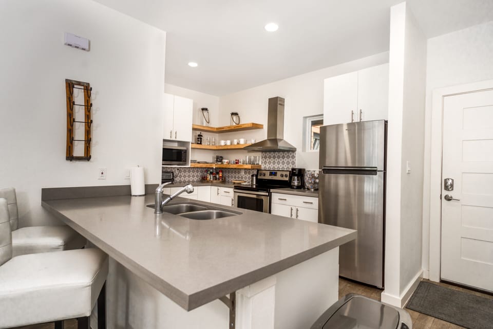 Full stocked Kitchen; stove, refrigerator, microwave, coffee maker pots and pan.