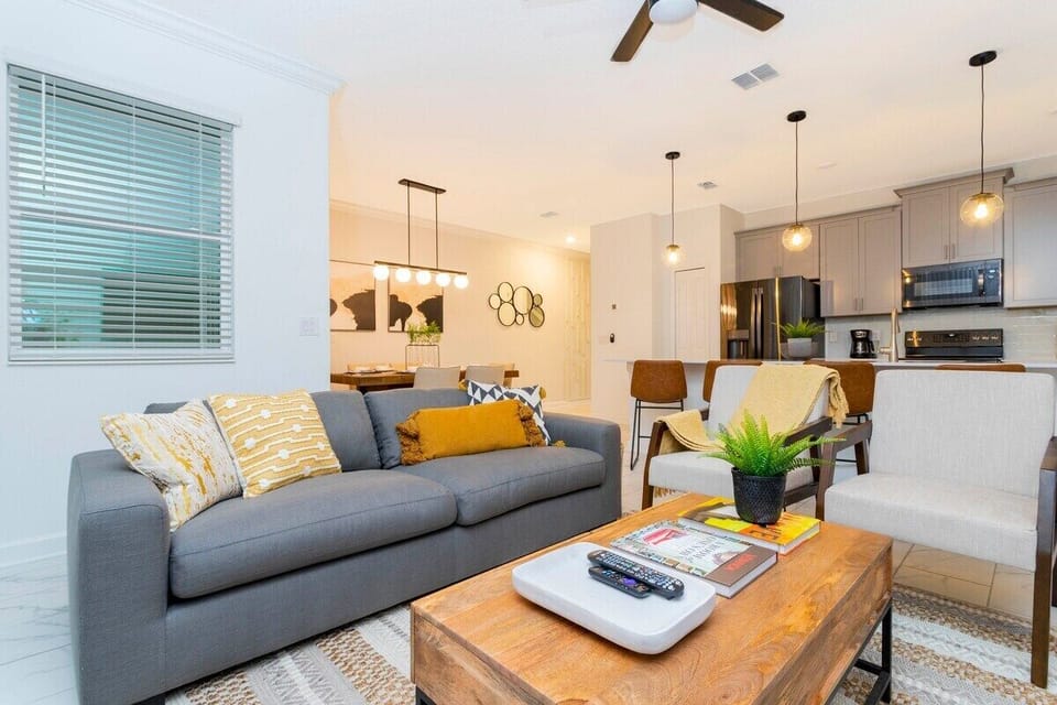 Step into this spacious, comfortable living area. The expansive room is adorned with tasteful decor, offering a blend of modern aesthetics and homey warmth. 