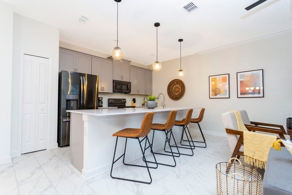 The fully equipped kitchen features modern appliances, sleek cabinetry, and all essential cookware and utensils, making it perfect for preparing meals with ease.