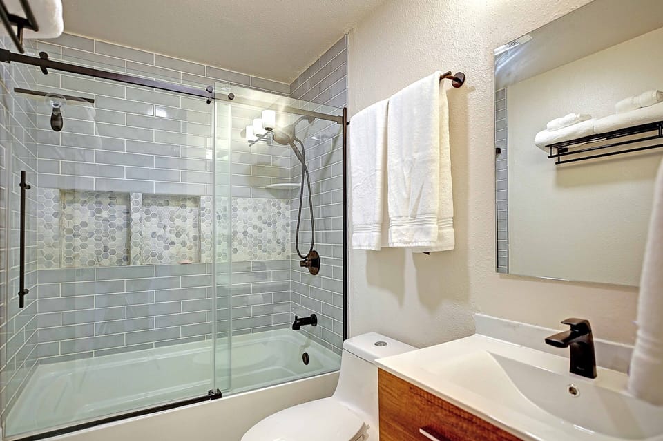 Large main floor bathroom with tub/shower and large sink.
