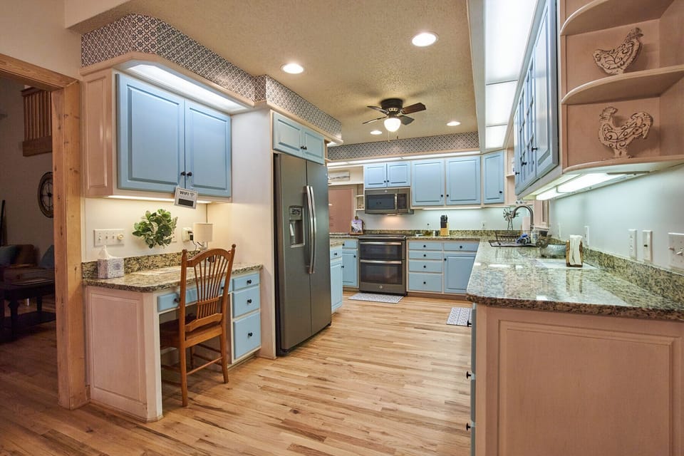 Fully stocked kitchen includes double oven, dishwasher, and full refrigerator.