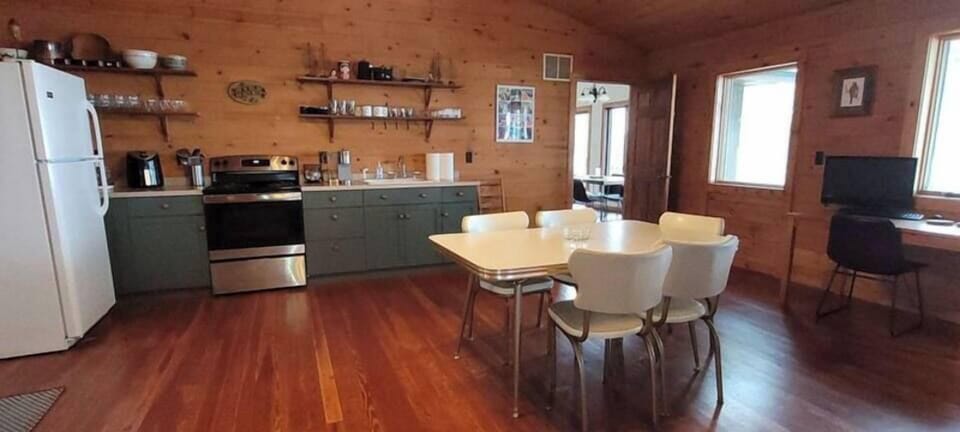 The additional suite includes a kitchenette, dining area, living room, work space, bedroom with Queen bed, and a full bathroom.