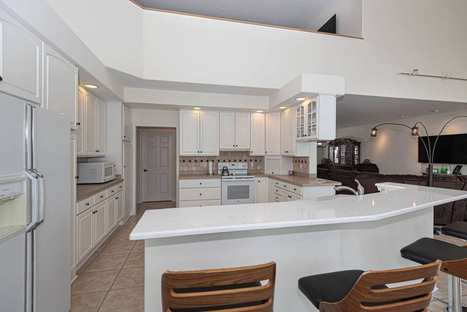 LLarge fully equipped kitchen with ample counter space, modern appliances, and everything you need to prepare meals during your stay.