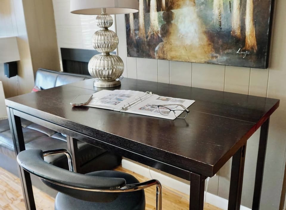 Main floor writing table work station right off the living room with large view windows and balcony.
