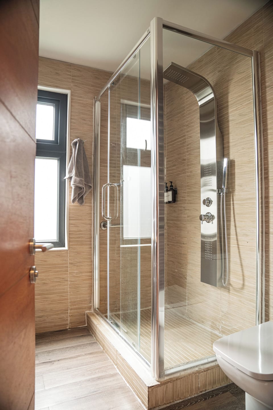 Shower, rainfall showerhead, hair dryer, towels