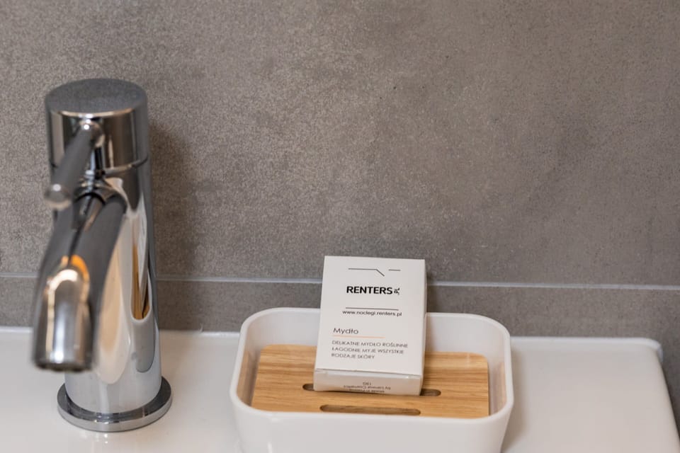 A wooden bathroom shelf neatly displaying a set of skincare products, adding a luxury touch.