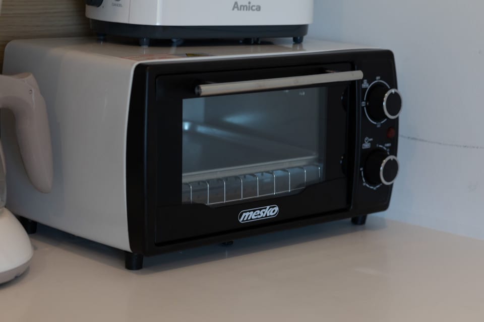 A close-up of a black microwave placed on a kitchen countertop, highlighting the appliance's modern design.