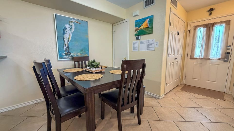 Your cozy dining space welcomes you with warm natural light and thoughtful coastal touches, perfect for sharing meals together.