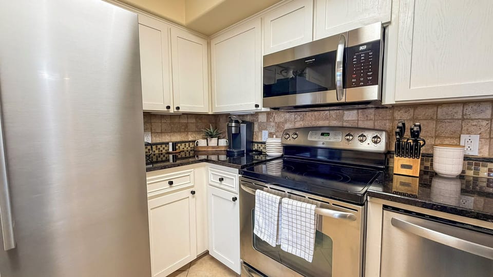 Your fully equipped kitchen awaits with stainless steel appliances, granite counters, and everything you need to create memorable meals during your stay.