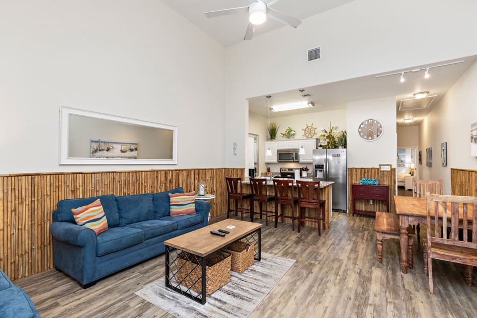 Relax in your stylish open-concept space where bamboo accents meet modern comfort, complete with a fully equipped kitchen and cozy living area.