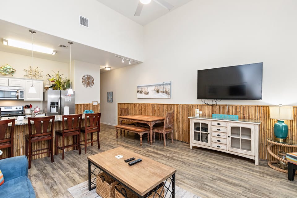 Relax in your open-concept living space with bamboo accents, vaulted ceilings, and coastal charm perfect for memorable vacation moments.