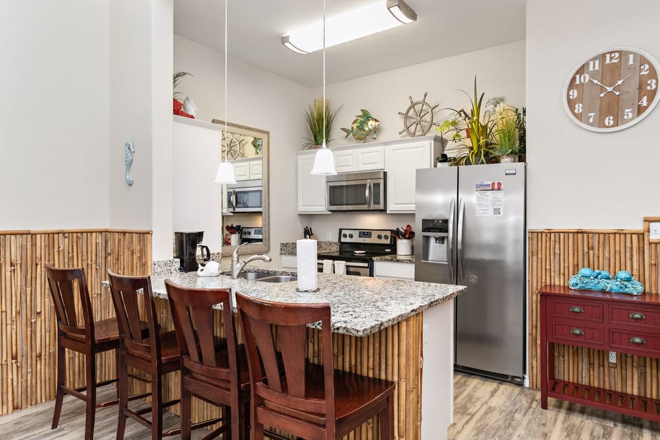 Gather around your fully-equipped kitchen island with granite counters, stainless appliances, and nautical touches for memorable meals.