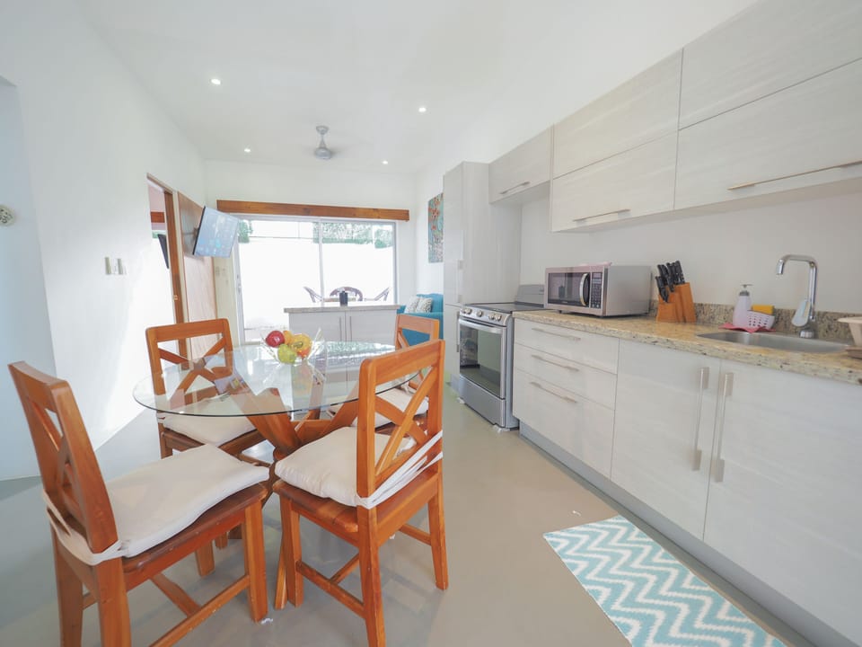 Deluxe Condo | Private kitchen | Full-size fridge, microwave, oven, rice cooker