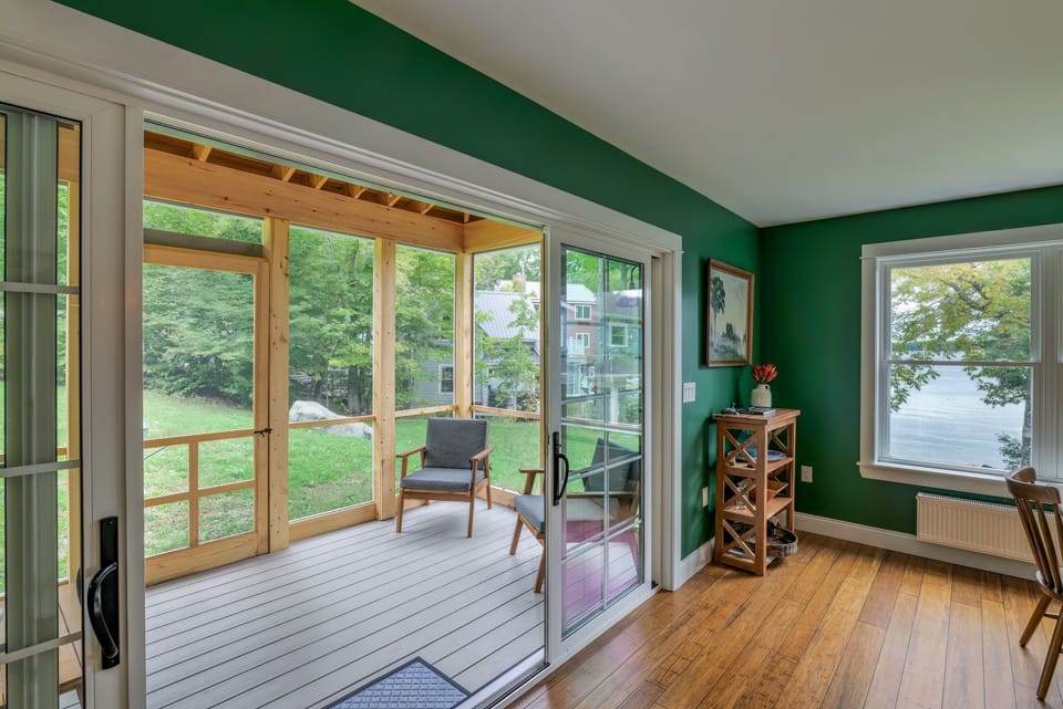 Sliding doors connect the kitchen and dining area directly to the screened porch